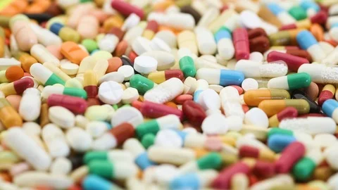 View of many different colorful pills spinning Stock Footage 97053823