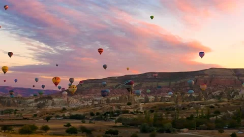 View of many hot air balloons flying in the sky during sunset, Cappadocia Stock Footage 239178799