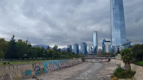 View of the Mapocho River flowing through central Santiago, Chile, with the Stock Footage 340825469