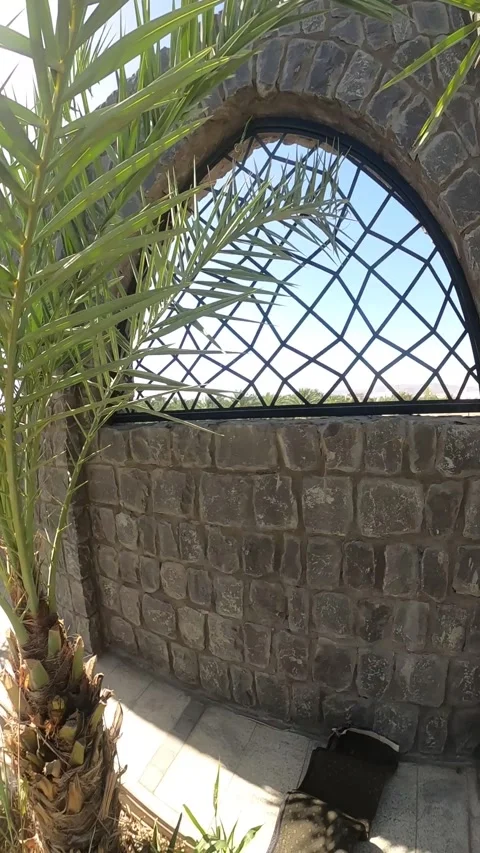 View of Masjid Quba Through a Stone Arch Window Stock Footage 346191999