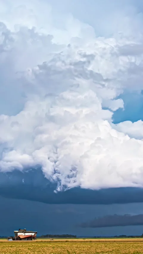 View of massive storm clouds over a golden field, Latvia. Stock Footage 339951551