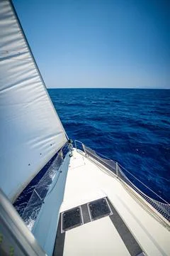 View from the mast down to the bow of a sailing yacht moving under full sails Stock Photos