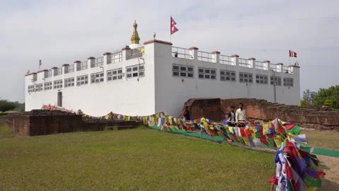 View of the Maya Devi Temple with prayer flags in Lumbini, Nepal. 스톡 동영상 335469429