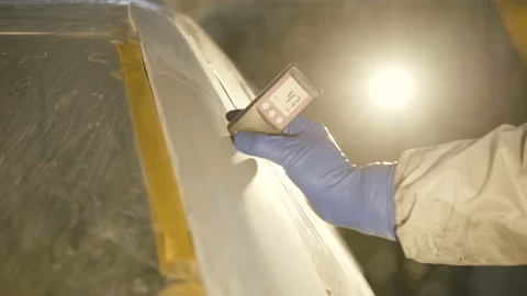 View of measuring a thickness of primer on a car surface using a thickness gauge Stock-Footage 86870131