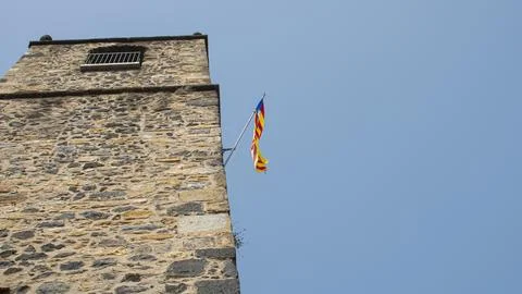 View of a medieval tower with the Catalan flag. Stock Photos