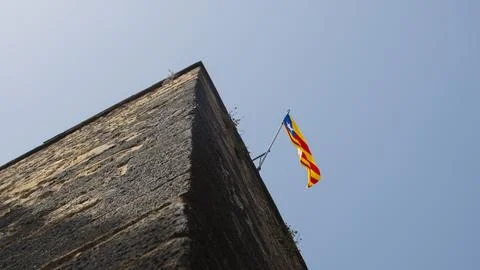 View of a medieval tower with the Catalan flag. Stock Photos