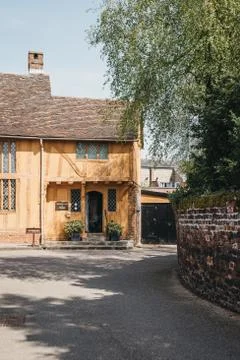 View of medieval yellow half-timber framed Little Mall Museum in Lavenham, UK Stock Photos