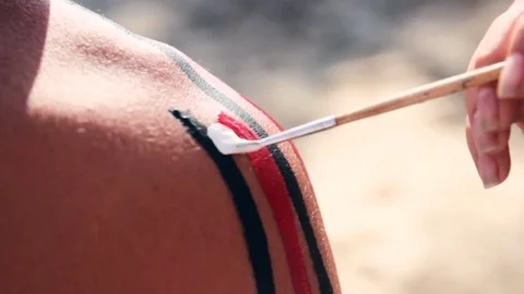 View of mehndi master painting on model's back Stock Footage 70802462