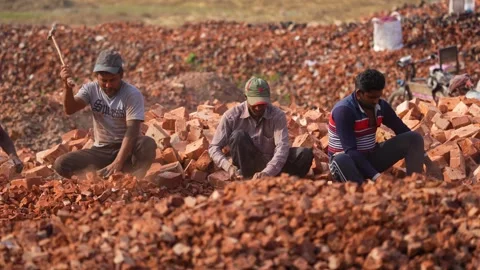 View of men breaking red bricks with hammers in Bogura, Bangladesh. 스톡 동영상 334980877