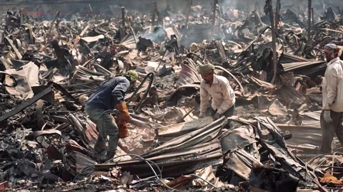 View of men clearing charred debris after a massive fire, Bangladesh. Video stock 335562832