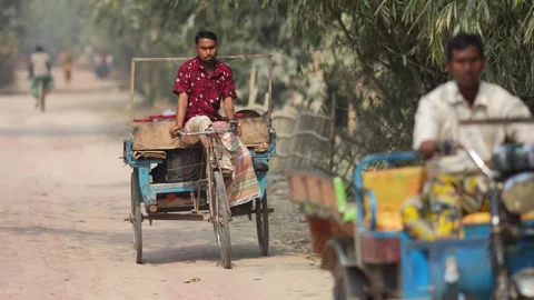 View of men driving cargo rickshaws on a rural road, Bangladesh. 스톡 동영상 334971001