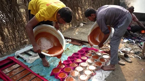 View of men pouring molasses into molds in Natore, Bangladesh. Видео 335651395