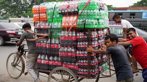 View of men pulling a cart loaded with soda bottles, Bangladesh. Stock Footage 335556651