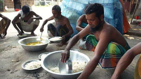 View of men serving rice during a communal meal in Bangladesh. Video stock 335557310