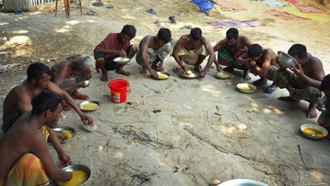 View of men sitting in a circle eating together in Natore, Bangladesh. Video stock 335558024