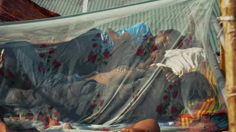 View of men sleeping under a mosquito net at Sadarghat, Bangladesh. Stock Footage 335600407