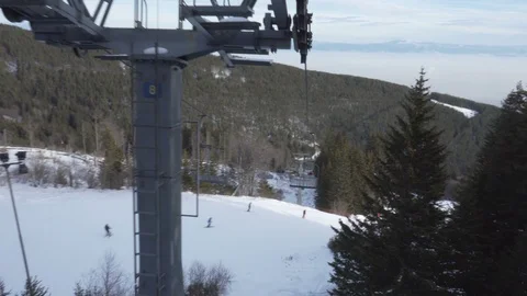 View of a metal tower of a fully functioning chairlift system 動画素材 103165991