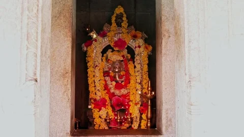 View of metallic ganesha idol adorned with floral garland in sacred spiritu.. Stock Footage 340967578