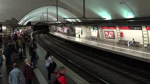 View of metro train arrive in Barcelona subway station commuter people travel Stock Footage 82372340