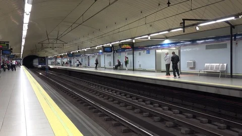 View of metro train arrive in Madrid city station people wait on subway platform Stock Footage 81979109