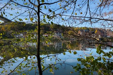 View of the Meuse river from behind tree branches in Dinant, Belgium Stock-Fotos