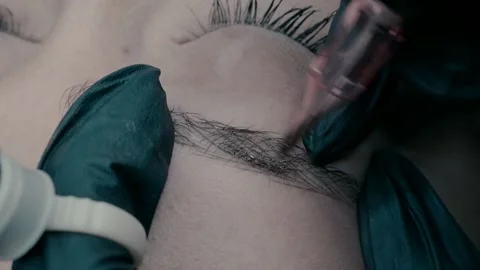 View of microblading master at work makes a pigment on the eyebrow. close up 4 Stock Footage 223157944