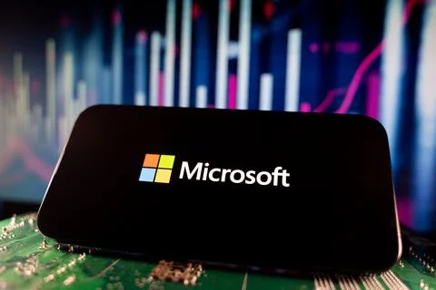 View of Microsoft logo on smartphone screen with financial charts. Toronto, Stock Photos