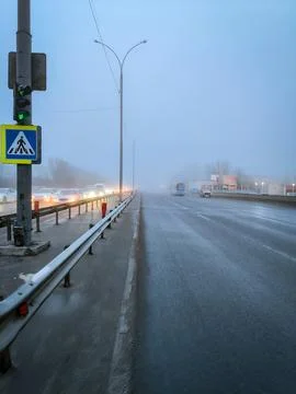 View from the middle of the road into perspective where you can see the fog. Stock Photos