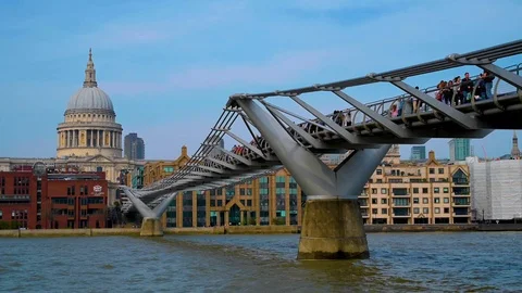 The view of Millennium Bridge and St. Pauls Cathedral across the River Thames Stock Footage 113658113