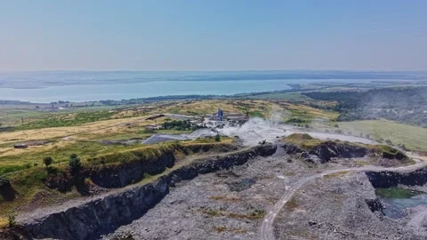 View of a mining site near a lake on a sunny day during summer Stock Footage 339053998