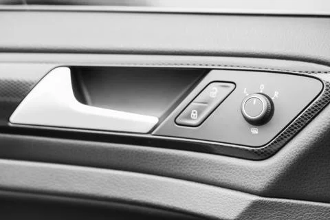 View of mirror and lock controls on door panel in modern car, closeup Stock Photos