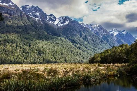 A view of Mirror Lakes with the mountains in the background and a forest in.. Stock Photos