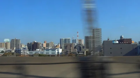 View of modern buildings from moving train window, Japan, copy space Stock Footage