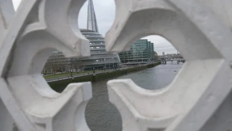 A view of modern buildings on a riverside through a decorated wall. Stock Footage 122763939
