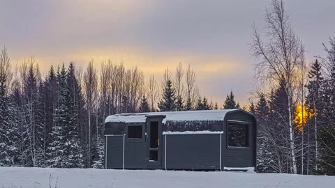 View of a modern cabin in a snowy forest, Latvia. Video stock 340640592