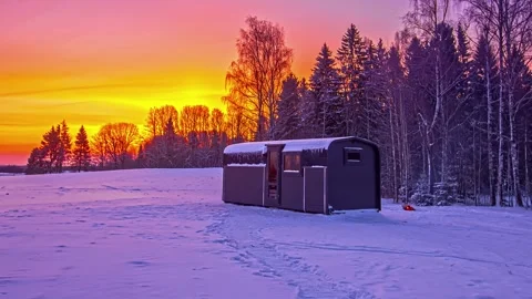 View of a modern cabin in a snowy landscape in Latvia. Video stock 340639075