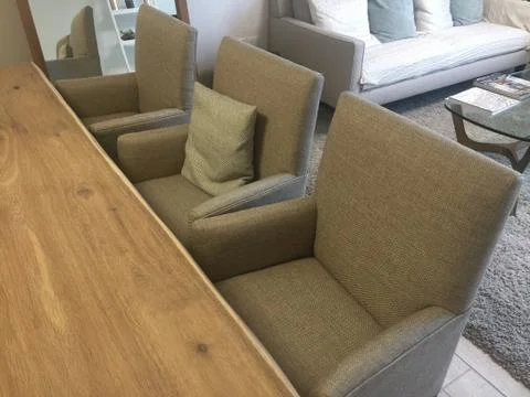 View of modern dining table and cloth chairs in a living room. Close Up view  Stock Photos