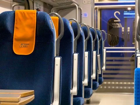 A view of a modern PKP Intercity train interior featuring rows of blue Foto stock