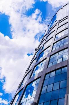 View on modern skyscrape, workers on the ropes cleaning windows Stock Photos