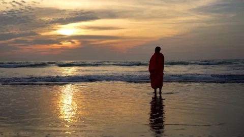 View of a monk standing on the beach at sunset in Bangladesh. Video stock 335022531