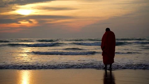 View of a monk standing on the beach at sunset, Bangladesh. 스톡 동영상 335022578