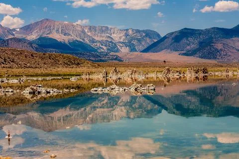 View of Mono Lake and mountains range reflecting in crystal water Stock Photos