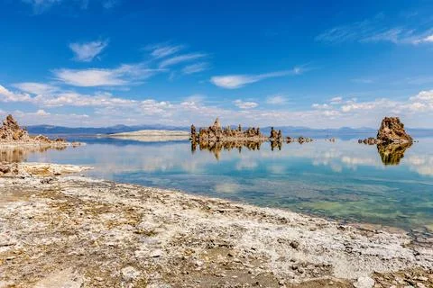 View of Mono Lake rock formations rflecting in crystal clear water Stock Photos