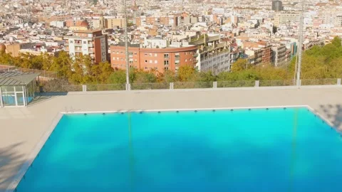 VIew of Montjuic pool in Barcelona, Spain revealing scenic cityscape on sunny Stock Footage 305161332