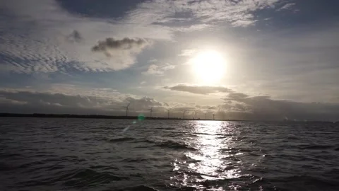 View of morning sky with distant windmills and light clouds. Stock Footage 142673019