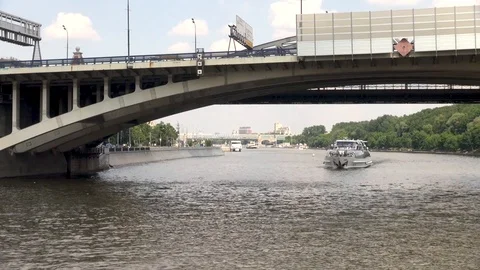 View from Moscow River on road bridge.  Under bridge sailing pleasure boat. Stock Footage 106169124