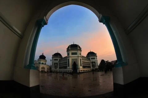 View of mosque in town square from arch way Stock Photos