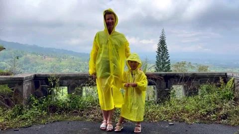View on mother and small kid standing on the terrace of hotel in yellow Stock Footage 276465124