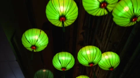 Up view motion under chinese green and red lanterns hanging on the night narrow Stock Footage 292867098
