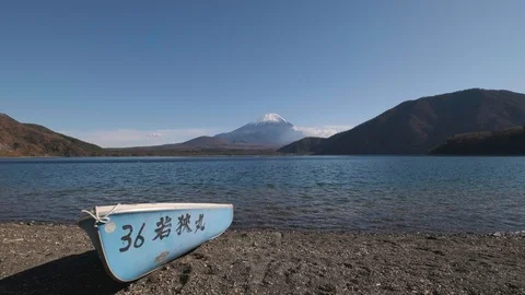 View of Mount Fuji and row boat from lake Motosu, Yamanashi Prefecture, Japan Stock Footage 99090310